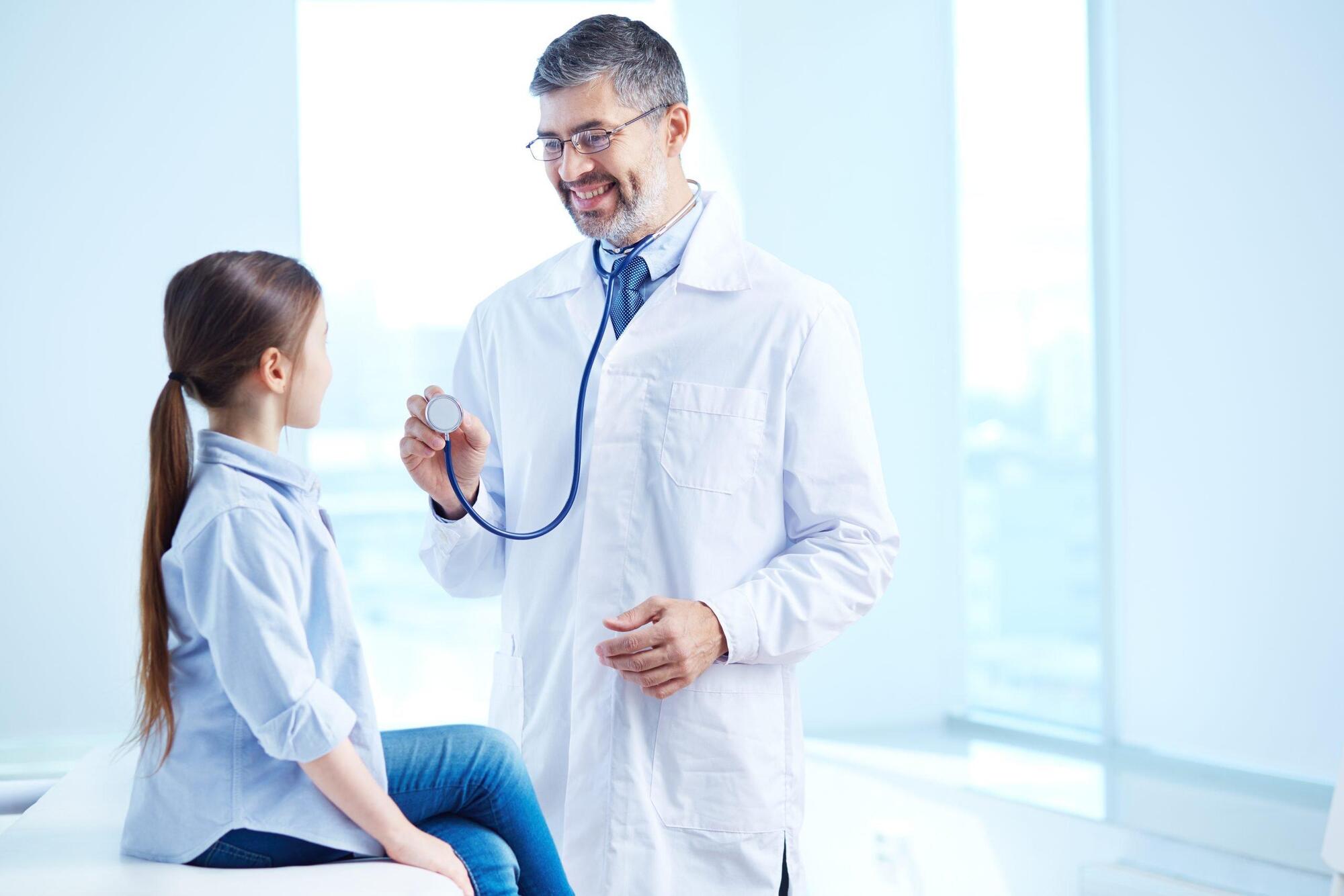 doctor-examining-his-young-patient-scaled