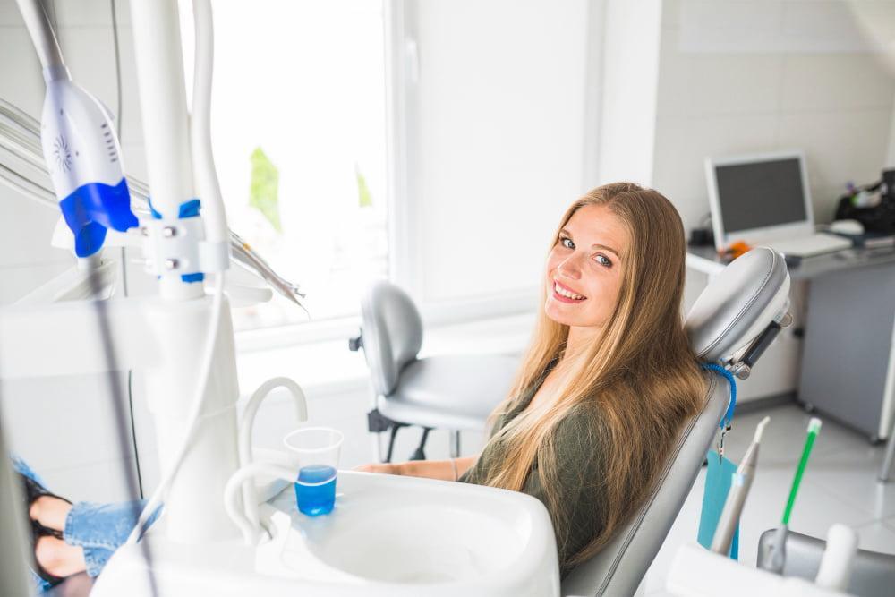 happy-young-woman-sitting-dental-chair