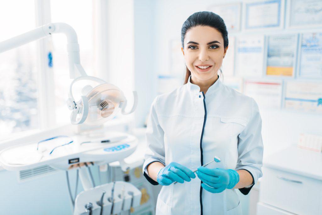 smiling-female-dentist-uniform-gloves-dental-clinic-professional-pediatric-dentistry-children-stomatology-scaled